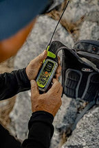 User holding ACR ResQLink 400 personal locator beacon outdoors for emergency signaling and GPS tracking