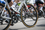 Cyclist riding road bike using Favero Assioma power meter pedals during road cycling race
