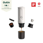 OutIn Nano portable electric espresso maker with espresso shot, capsules, and coffee grounds on white background